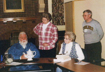 Bob Becker, left, examines a teapot to give an appraisal at the last Richfield Springs Historical Association meeting. 